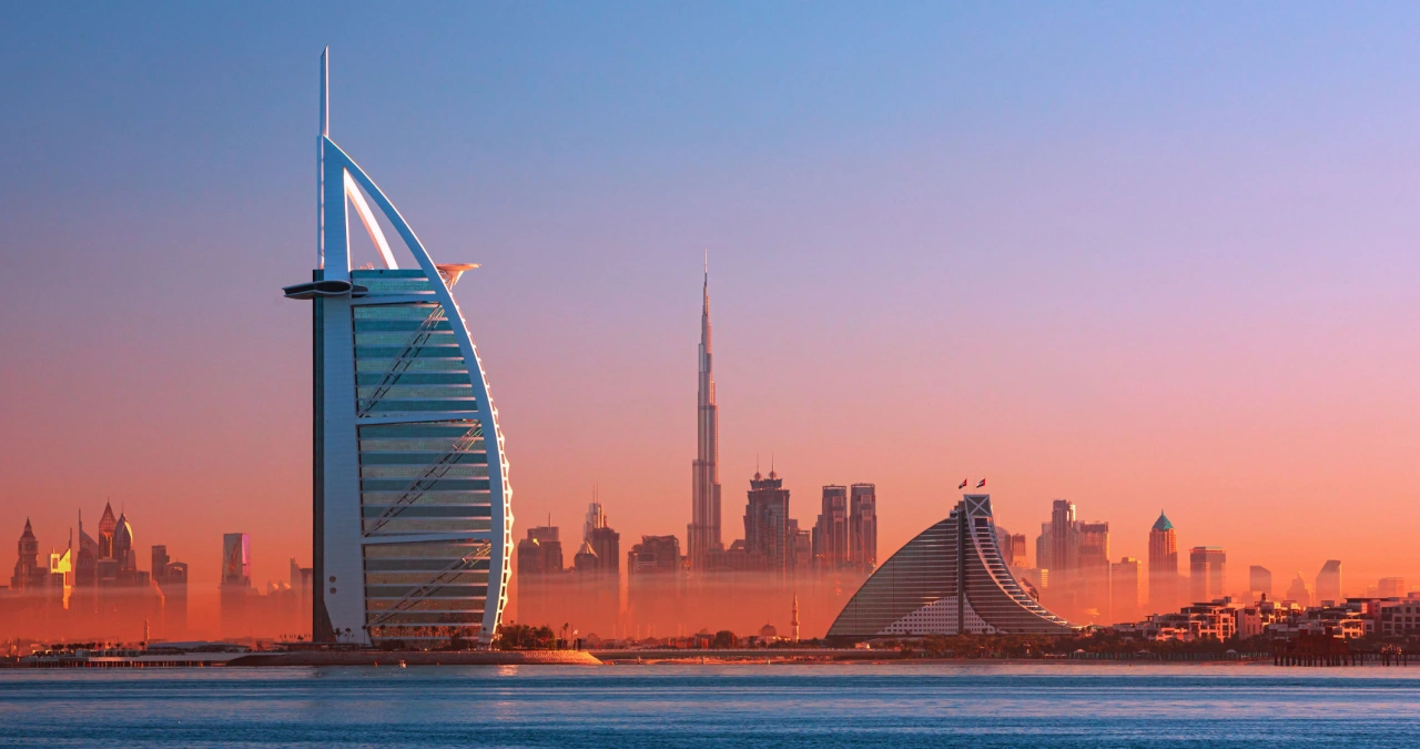 teach in uae, Dubai city - amazing city center skyline and famous Jumeirah beach at sunset, United Arab Emirates